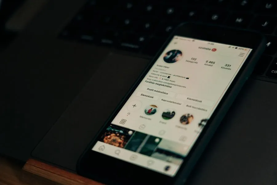 Phone and laptop showing a social media profile